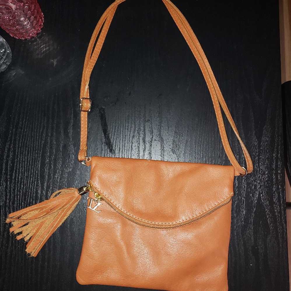 Brown leather purse with table and long strap